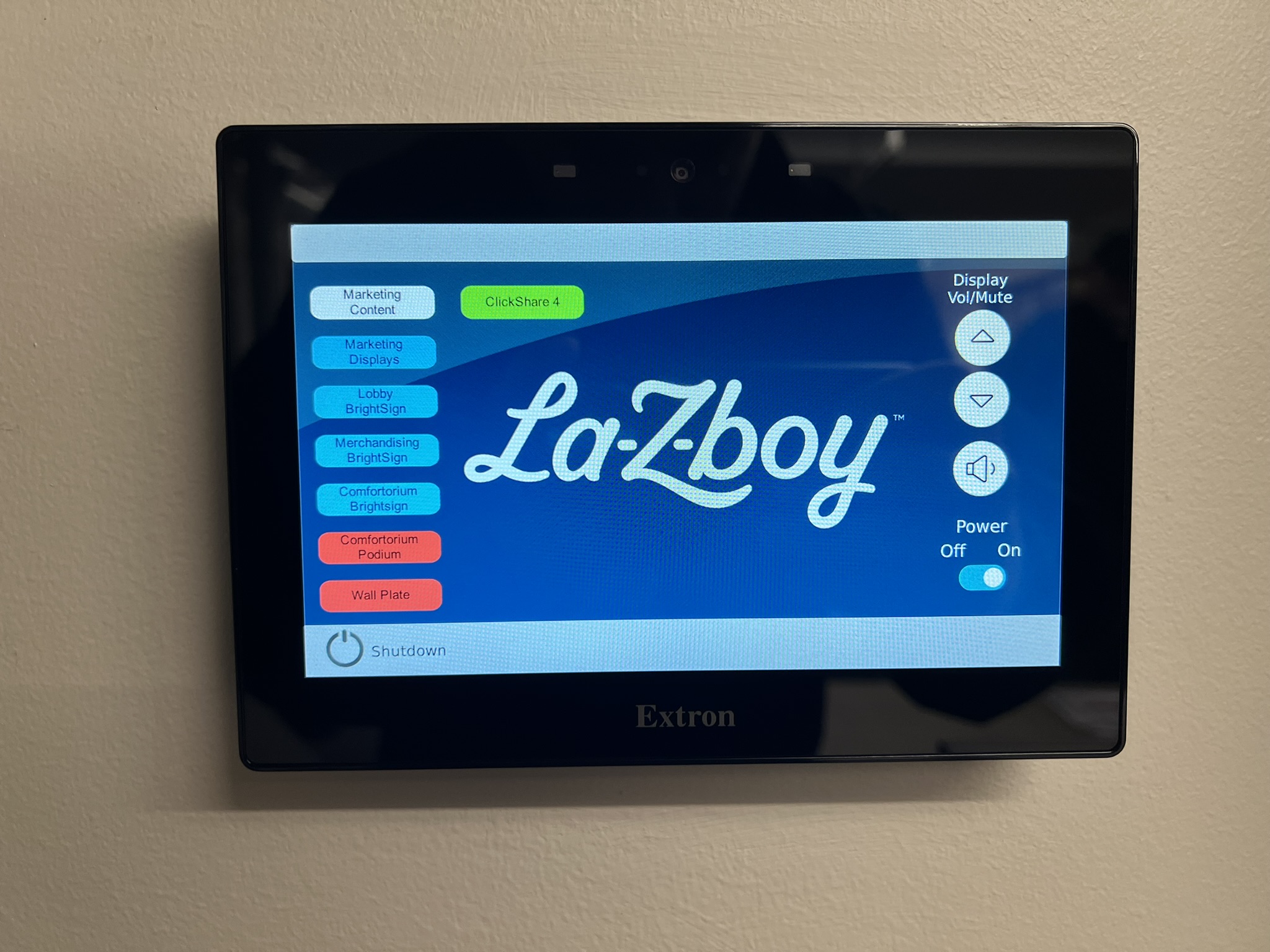 Extron touch panel with La-Z-Boy-branded control interface and per-zone source selection - CIAVL